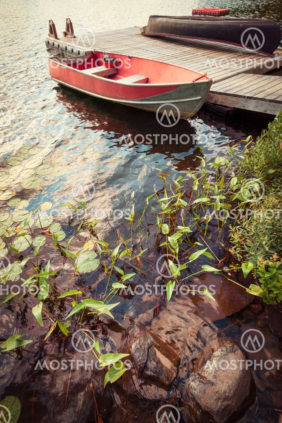 Boat at dock on small lake
