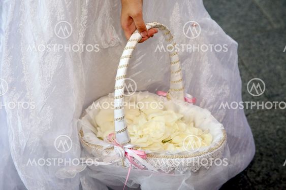 bridesmaids carrying a basket with rose petals