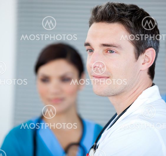 Charismatic male doctor looking at the window