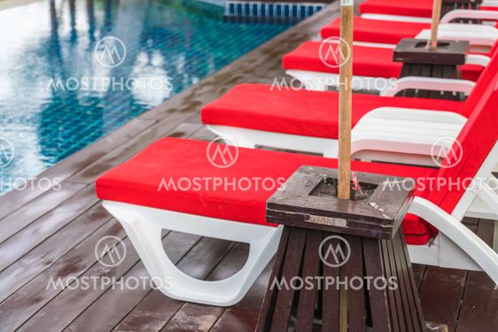 Beautiful beach chairs with umbrella around outdoor...