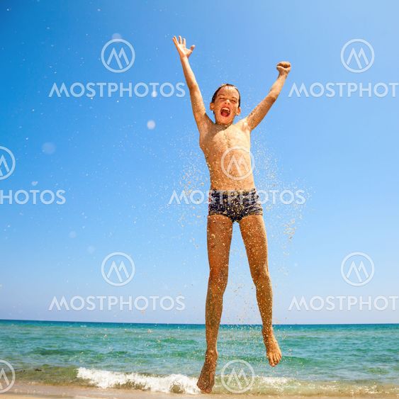 Boy jumping on the beach