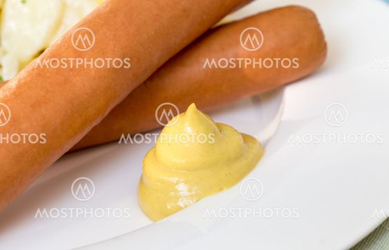 Vienna sausages with mustard close up