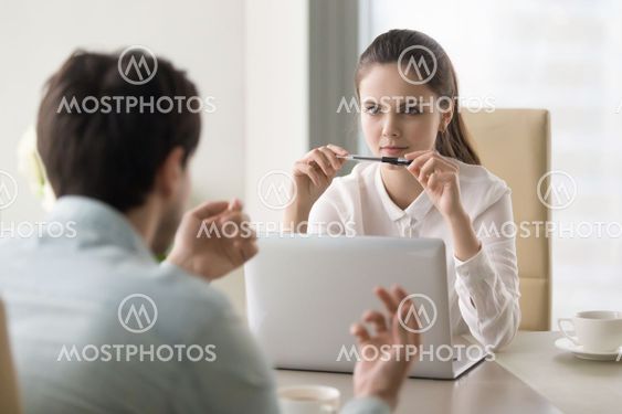 Businesswoman listening to male job applicant or considering bus
