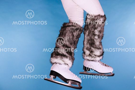 Woman legs wearing ice skates fur socks, skating