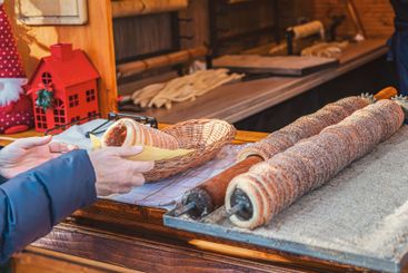 Warm pastry preparation at festive market stall with...