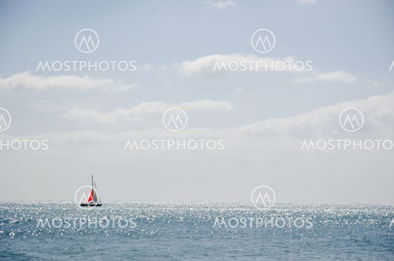 Yacht at glittering water