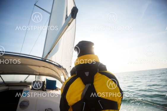 Rear View Of Mature Man Sailing On Yacht