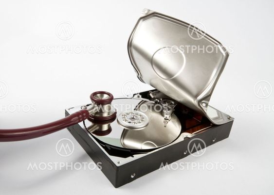 opened hard disk with stethoscope on grey background