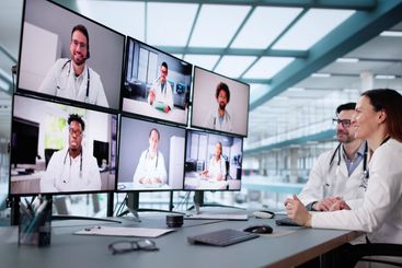 Male doctor in online video conference with female nurse