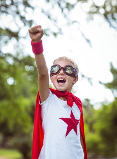 Little boy pretending to be superhero