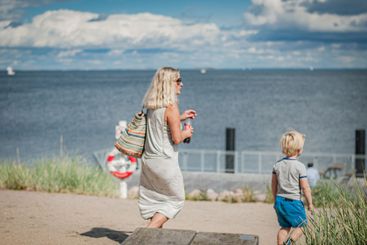 Mother and son walking by the Oresund sea, Denmark