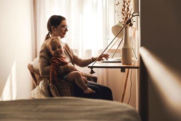 Woman working at home with her baby
