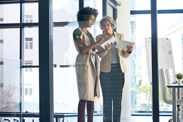 Business women, writing and planning with tablet for...