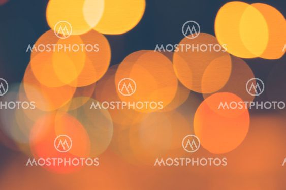 Abstract background of orange blurred lights with bokeh effect
