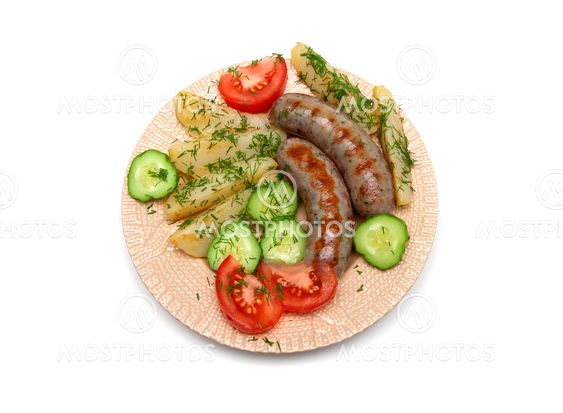 appetizing grilled sausages with vegetables on a plate