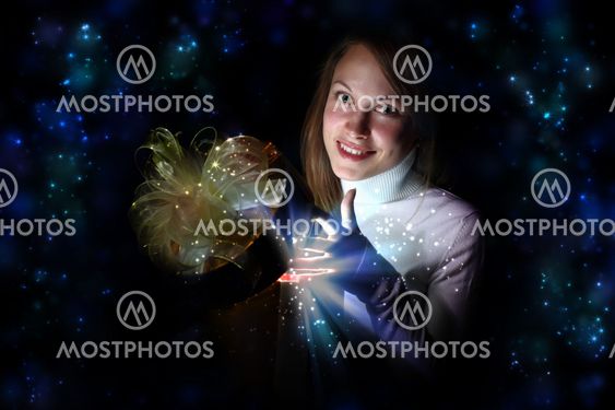 Young woman reading a magic book