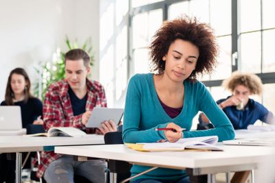 Student concentrating while writing an essay during class...