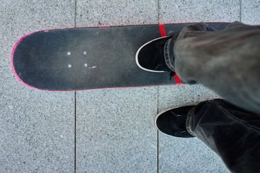 Top view of skateboarder riding on skateboard on road