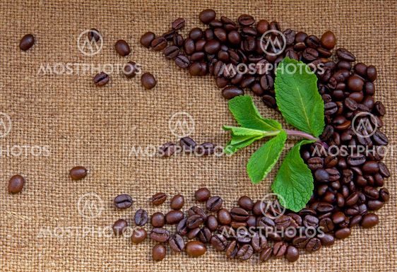 Heap of burnt brown arabica coffee beans