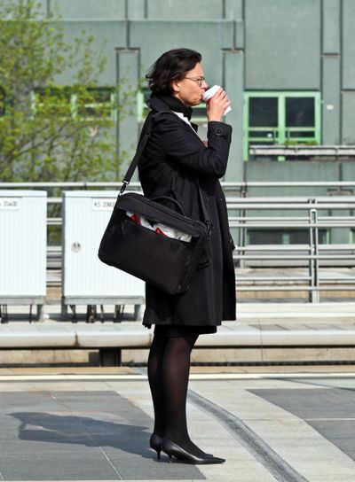 Affärskvinna dricker ta med kaffe