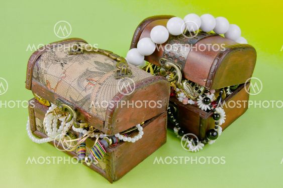 two small boxes with treasures on a light green background