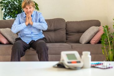 An old woman measures her blood pressure. Selective focus.