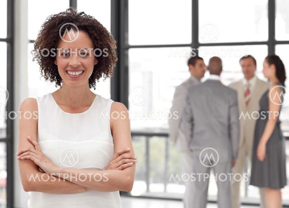 Beautiful Businesswoman arms folded with his colleagues