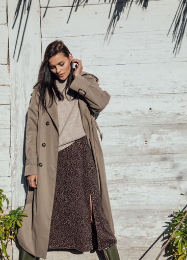 Beautiful fashionable brunette woman in gray autumn coat