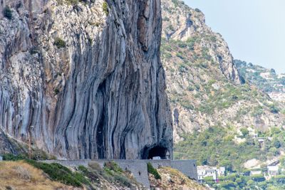 Daylight view to big mountains with trees and buildings