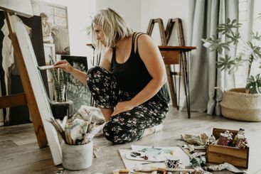 Art, creativity and paint, woman in home studio with...