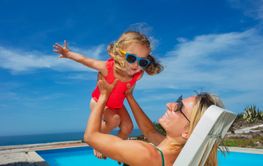 Bonding moment for mother and daughter play airplane...