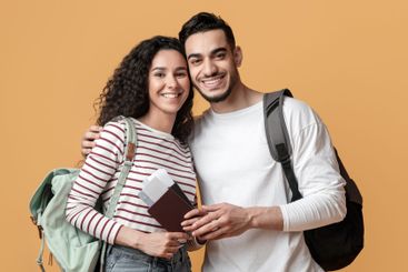 Portrait Of Smiling Arab Travellers Couple With...