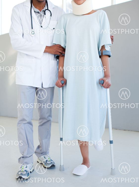 A physical therapist helping a patient with neck brace and on crutches