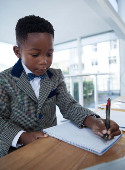 Serious businessman writing on report