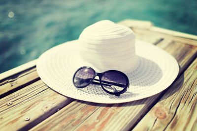 close up of hat and sunglasses at seaside