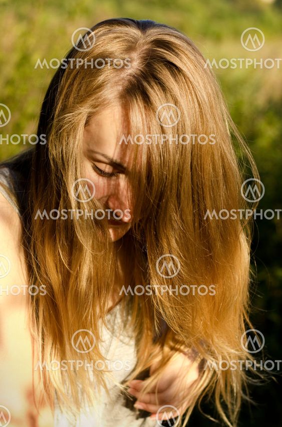 Blond young woman in a park