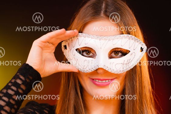 Woman holds carnival mask closeup