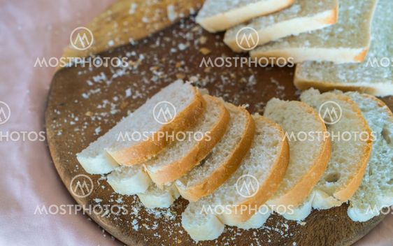Sliced white bread on wood