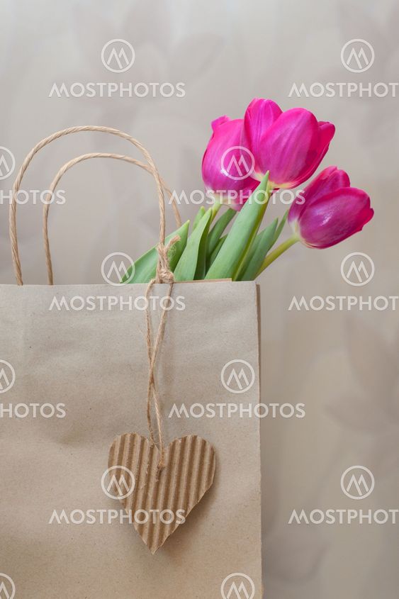 three purple tulip and paper heart with place for text