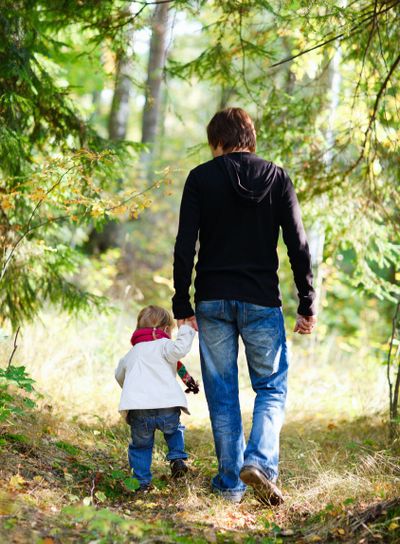 Father and daughter walking in park