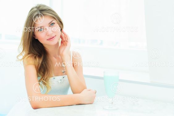 Portrait of a cute woman in a city cafe