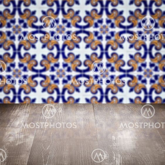 Wood table top and blur vintage ceramic tile pattern wall