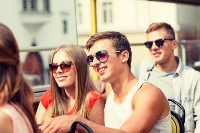 smiling couple traveling by tour bus