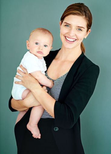 Business woman, baby and smile in studio for motherhood,...
