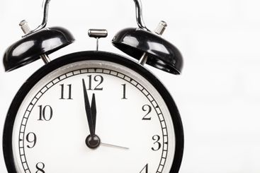 Close up of a black vintage alarm clock