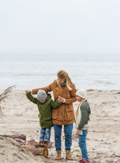 mother and kids on seashore