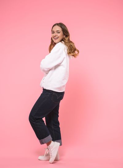 Full length image of Smiling woman wearing in casual...