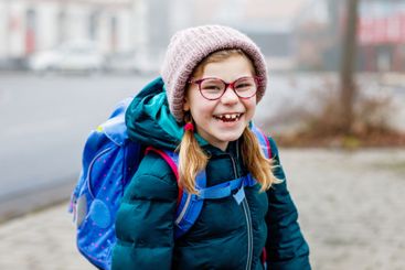 Cute little girl o the way to school. Healthy happy...