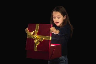 Little girl opening a present
