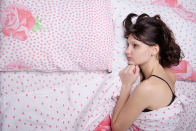 Young lonely girl bored in bed